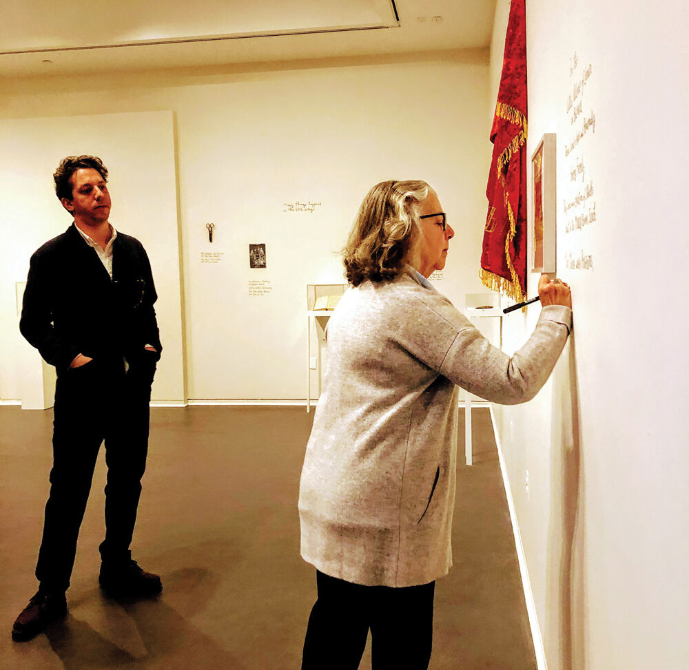 Alex Kalman watches as Maira Kalman finishes writing the text for their exhibition at the National Museum of American Jewish Heritage in Philadelphia